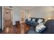 Comfortable living room featuring a blue sofa and chair with hardwood floors at 478 N Pin Oak Pl # 308, Longwood, FL 32779