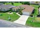 Home featuring an attached garage, meticulously maintained lawn, and vibrant flower beds at 2172 Nw 50Th Cir, Ocala, FL 34482