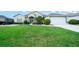 Charming home with lush lawn, complemented by vibrant flowerbeds and a convenient two-car garage at 2172 Nw 50Th Cir, Ocala, FL 34482