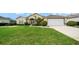 Charming home with lush lawn, complemented by vibrant flowerbeds and a convenient two-car garage at 2172 Nw 50Th Cir, Ocala, FL 34482