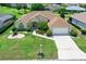 Charming home featuring an attached garage, manicured lawn, and colorful flower beds at 2172 Nw 50Th Cir, Ocala, FL 34482