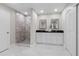 Modern bathroom with double sinks, sleek black countertops, and a tiled walk-in shower at 4790 Anderson Rd, Orlando, FL 32812