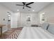 Well-lit bedroom with a ceiling fan showcasing access to the bathroom and closet at 4790 Anderson Rd, Orlando, FL 32812