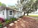 Charming updated cottage with fresh gray paint, landscaped yard, and lake view at 4790 Anderson Rd, Orlando, FL 32812