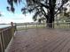 Inviting outdoor deck provides a serene waterfront view with a lake, big trees, and picturesque Spanish moss at 4790 Anderson Rd, Orlando, FL 32812