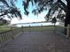 Inviting outdoor deck provides a serene waterfront view with a lake and picturesque Spanish moss at 4790 Anderson Rd, Orlando, FL 32812