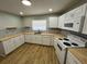 Bright kitchen featuring white cabinets, butcher block counters and stainless steel appliances at 2308 Lake Helen Osteen Rd, Deltona, FL 32738