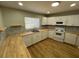 Charming kitchen featuring white cabinets, butcher block countertops, and tile backsplash at 2308 Lake Helen Osteen Rd, Deltona, FL 32738