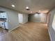 View of the living room, highlighting the wood-look floors, recessed lighting, and access to the kitchen at 2308 Lake Helen Osteen Rd, Deltona, FL 32738