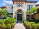 Elegant home with a stone-accented facade, arched entryway, and professionally landscaped grounds at 1911 Lake Markham Preserve Trl, Sanford, FL 32771