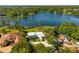 Expansive aerial view of the property showcasing its lakefront location, surrounding greenery, and neighborhood at 1305 W Lake Mary Blvd, Lake Mary, FL 32746