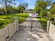 Gated property featuring a long driveway, sprawling lawn, and a well-maintained landscape leading to the house at 1305 W Lake Mary Blvd, Lake Mary, FL 32746