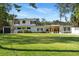 Charming two-story home featuring a rooftop terrace, lush lawn, and a serene setting amongst mature trees at 1305 W Lake Mary Blvd, Lake Mary, FL 32746
