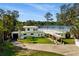 Stunning lakefront home with a spacious lawn, a rooftop terrace, and beautiful architectural details at 1305 W Lake Mary Blvd, Lake Mary, FL 32746
