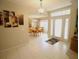 View of a tiled foyer, dining room, and glass paneled front door at 1201 Thornbury Ct, Winter Garden, FL 34787
