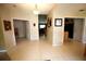 Hallway with beige tile floors leading to multiple rooms at 1201 Thornbury Ct, Winter Garden, FL 34787