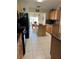 Open kitchen with stainless steel appliances, an 'EAT' sign, and adjoining dining area at 1201 Thornbury Ct, Winter Garden, FL 34787