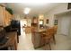 Spacious kitchen with granite countertops, tiled floors, and wooden bar stools at 1201 Thornbury Ct, Winter Garden, FL 34787