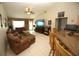 Spacious living room with tile floors, a ceiling fan, and a view of the backyard at 1201 Thornbury Ct, Winter Garden, FL 34787
