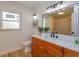 Updated bathroom with wood vanity, quartz countertop, and modern lighting at 965 Tuskawilla Rd, Winter Springs, FL 32708