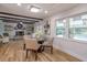 Charming dining room with hardwood floors, a round glass table, and views of the pool at 965 Tuskawilla Rd, Winter Springs, FL 32708