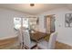 Elegant dining room with hardwood floors, a wood table, and modern lighting fixture at 965 Tuskawilla Rd, Winter Springs, FL 32708