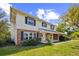 Charming two-story home features a brick facade, white siding, and a welcoming front porch at 965 Tuskawilla Rd, Winter Springs, FL 32708