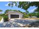 Two-car garage with long driveway and landscaping at 965 Tuskawilla Rd, Winter Springs, FL 32708