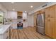 Modern kitchen with stainless steel appliances, white cabinets, and light wood countertops at 965 Tuskawilla Rd, Winter Springs, FL 32708