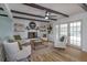 Bright living room features hardwood floors, exposed beams, a fireplace, and access to the backyard at 965 Tuskawilla Rd, Winter Springs, FL 32708