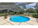 Inviting kidney-shaped pool with screened enclosure at 965 Tuskawilla Rd, Winter Springs, FL 32708