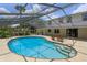 Relaxing kidney-shaped pool, screened patio, and home view at 965 Tuskawilla Rd, Winter Springs, FL 32708