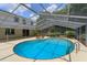 Refreshing kidney-shaped pool with screened enclosure at 965 Tuskawilla Rd, Winter Springs, FL 32708