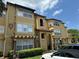 Exterior view of a multi-story residential building with architectural details and lush landscaping at 5132 Conroy Rd # 937, Orlando, FL 32811