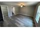 Large bedroom features wood-style flooring, a ceiling fan, and doors to a walk-in closet and the bathroom at 2 Fisher Lane Way, Ocklawaha, FL 32179