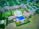 Aerial view of a community featuring a large pool, community center, and lush landscaping at 251 Silver Maple Rd, Groveland, FL 34736