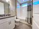 Clean bathroom with white tile tub/shower, neutral walls, and granite vanity at 251 Silver Maple Rd, Groveland, FL 34736