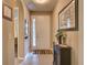 Inviting foyer featuring neutral colors, tile flooring, a white front door, and decorative accents at 251 Silver Maple Rd, Groveland, FL 34736
