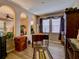 Comfortable home office with wood floors, arched entryways, bright windows, and neutral paint colors at 251 Silver Maple Rd, Groveland, FL 34736