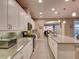 Modern kitchen featuring white cabinetry, granite countertops, stainless steel appliances, and tile flooring at 251 Silver Maple Rd, Groveland, FL 34736