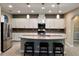 Bright kitchen features a granite island with seating, stainless steel appliances, and ample cabinet space at 251 Silver Maple Rd, Groveland, FL 34736