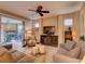 Comfortable living room with ceiling fan, neutral colors, patio access, and comfortable furniture at 251 Silver Maple Rd, Groveland, FL 34736