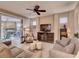 Comfortable living room featuring tile floors, a ceiling fan, and sliding glass doors to an outdoor patio at 251 Silver Maple Rd, Groveland, FL 34736
