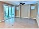 Bright living room with tile floor and sliding glass doors that lead to a screened patio at 251 Silver Maple Rd, Groveland, FL 34736
