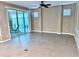 Bright living room with tile floor and sliding glass doors that lead to a screened patio at 251 Silver Maple Rd, Groveland, FL 34736