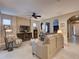 Spacious living room with ceiling fan, neutral colors, and comfortable furniture at 251 Silver Maple Rd, Groveland, FL 34736