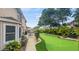 Spacious backyard featuring a putting green, patio with table and chairs, and manicured landscaping at 4436 Yachtmans Ct, Orlando, FL 32812
