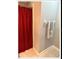 Clean bathroom with tile flooring and red shower curtain at 4436 Yachtmans Ct, Orlando, FL 32812