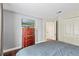 Bedroom features a chest of drawers with TV and a coordinating hardwood floor at 4436 Yachtmans Ct, Orlando, FL 32812