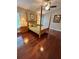 This bedroom features a four-post bed, hardwood floors, two side tables, and a window with blinds at 4436 Yachtmans Ct, Orlando, FL 32812